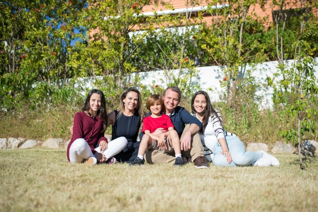 A joyful family enjoying sunny moments in a lush Portuguese garden.